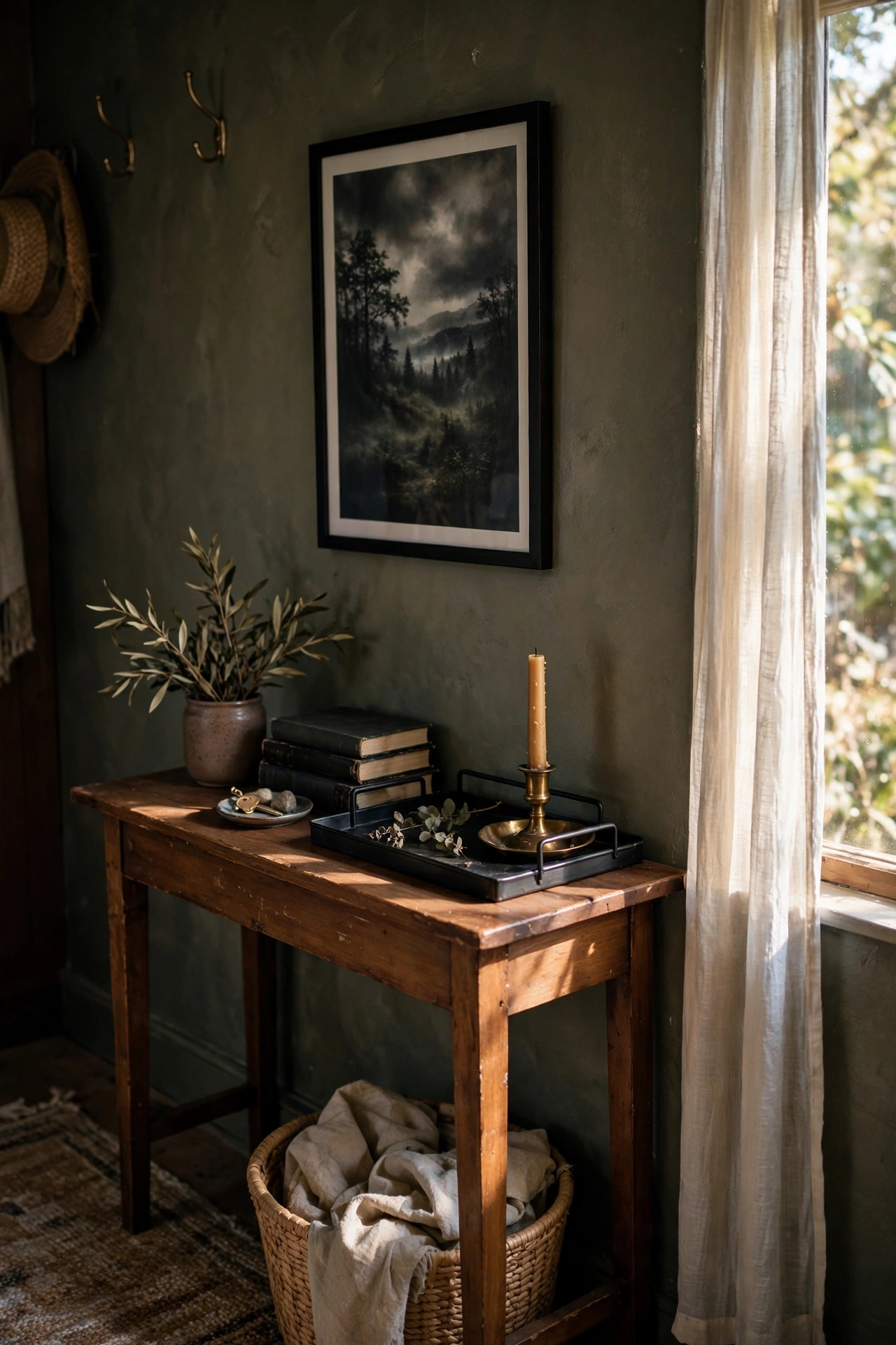 Small entryway table styled with dark tray, brass and books