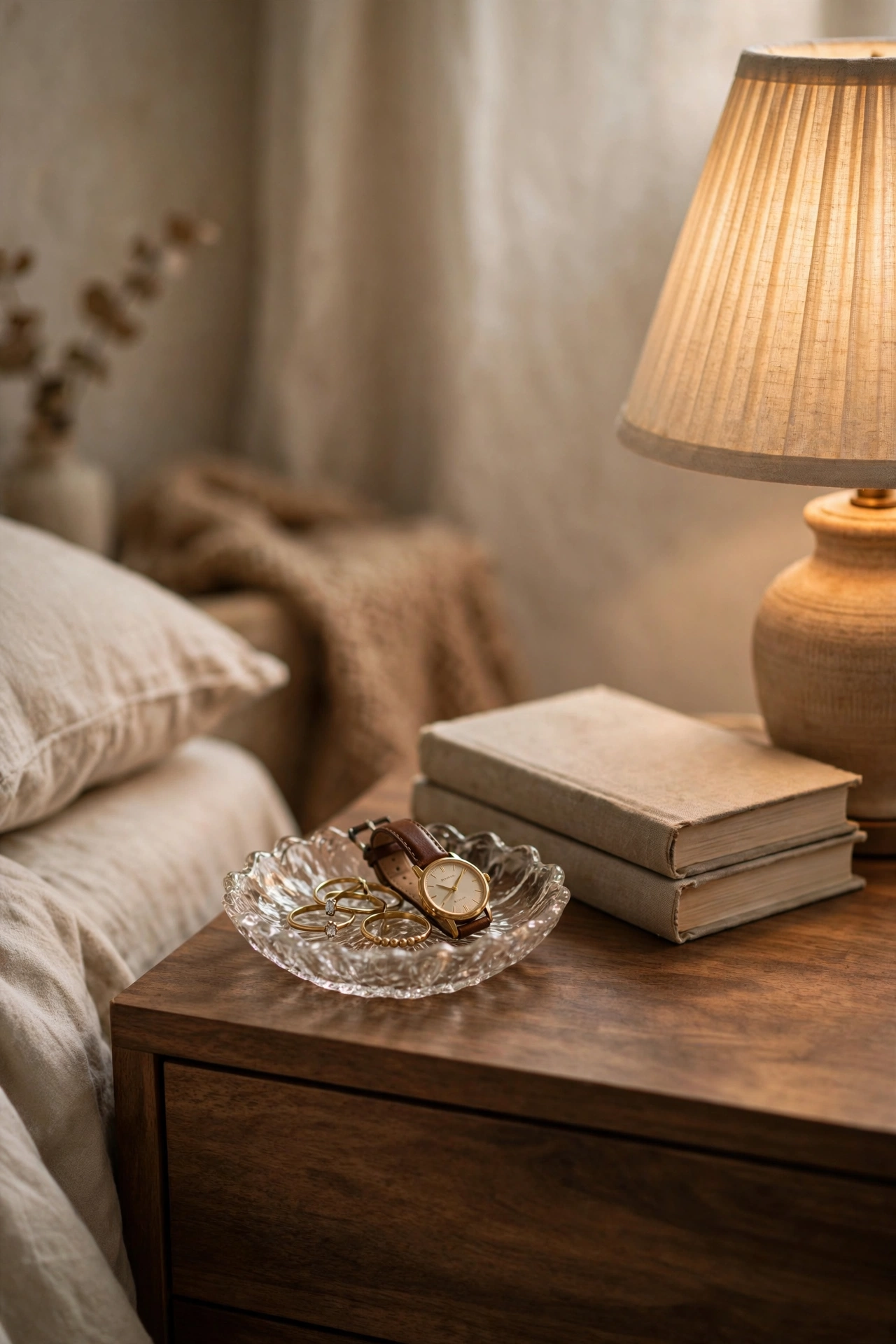 Glass trinket dish with rings and watch on a styled nightstand, dollar tree bedroom decor
