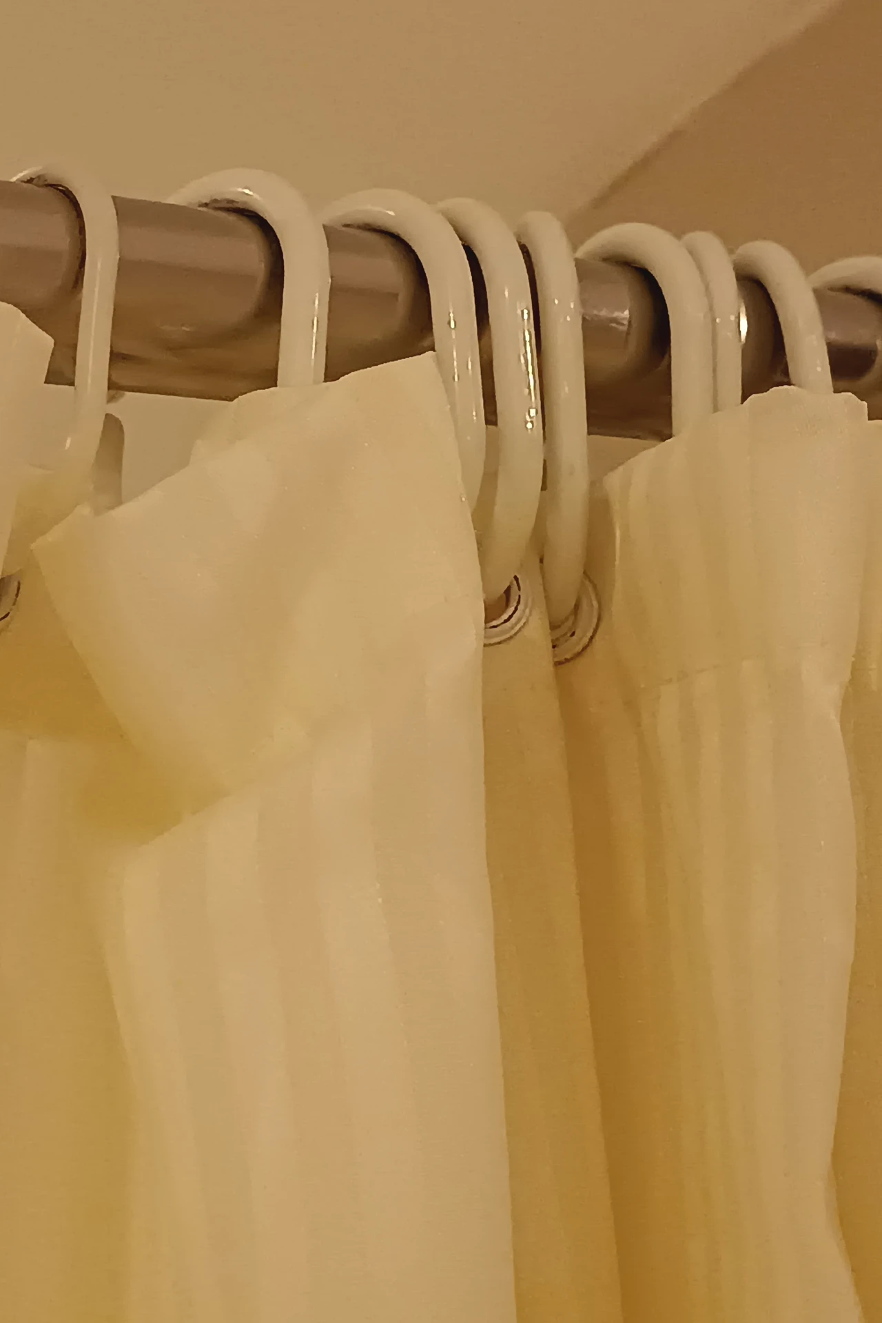 Crisp white waffle weave shower curtain in a bright clean bathroom