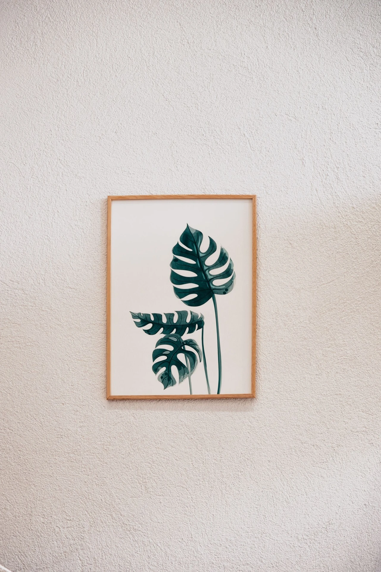 Botanical prints in matching black frames hanging on a bathroom wall