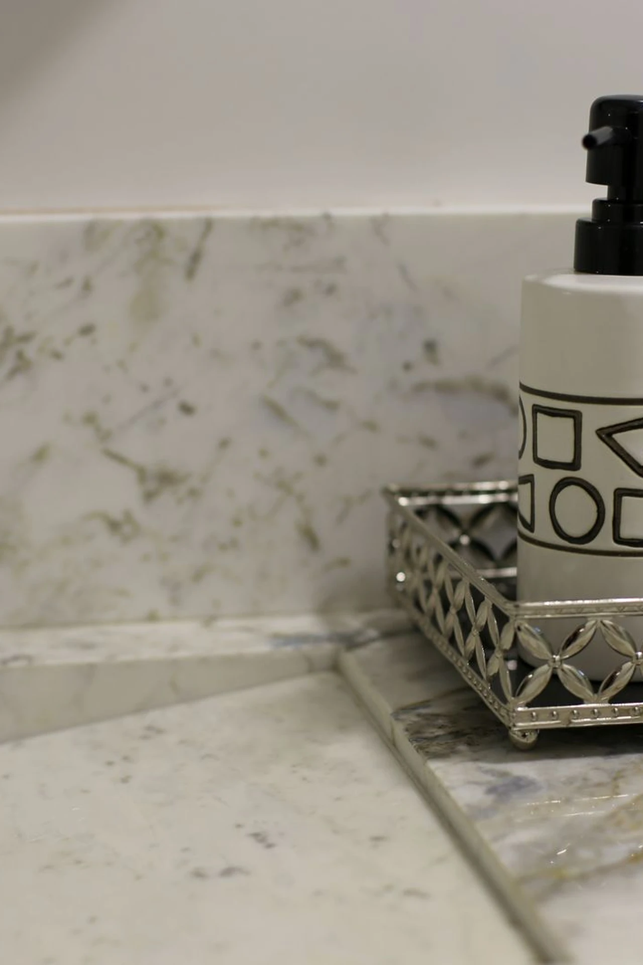 Tiered stand holding skincare cotton pads and small bathroom essentials on a counter