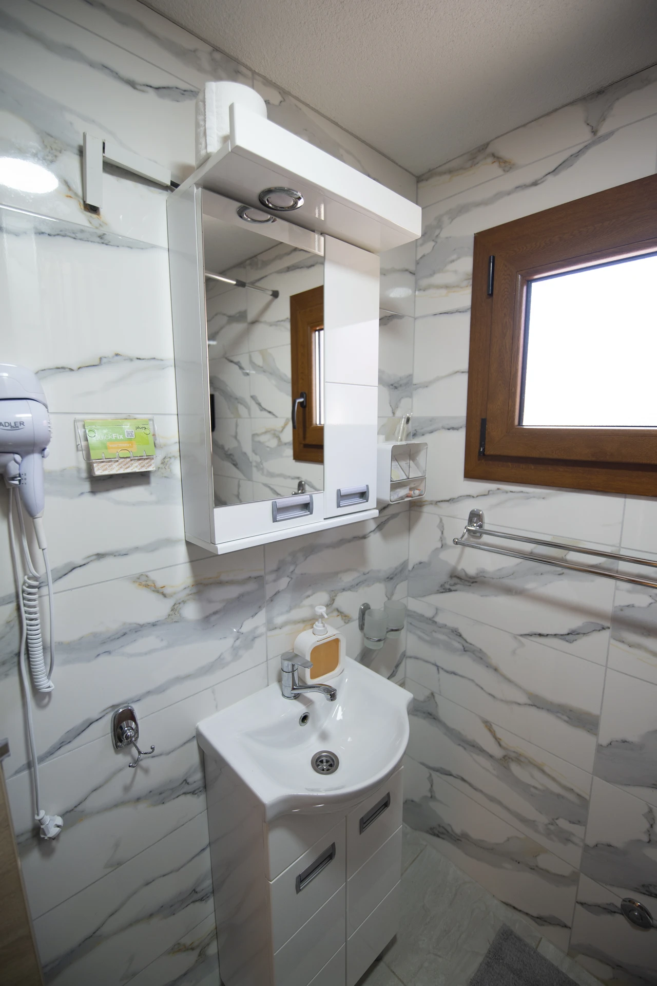 Bright white bathroom walls with modern fixtures and natural light