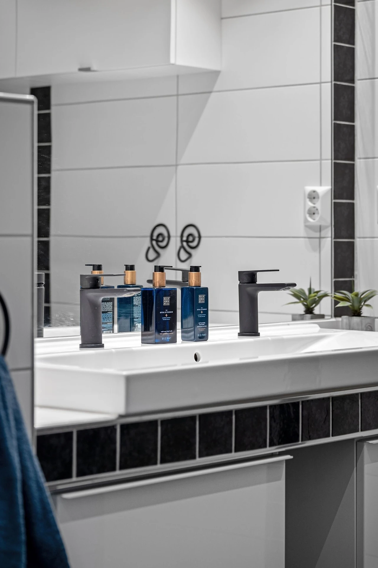Matching soap dispensers on a tidy modern bathroom vanity