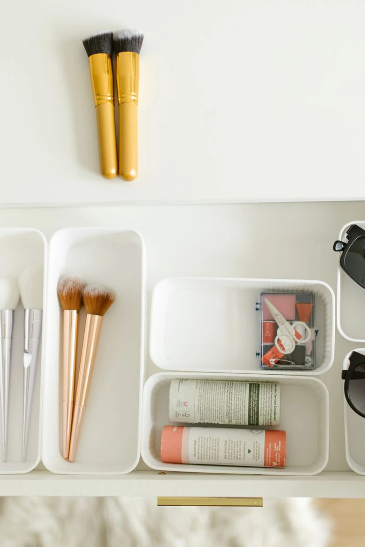 Organised bathroom drawer with small bins for toiletries