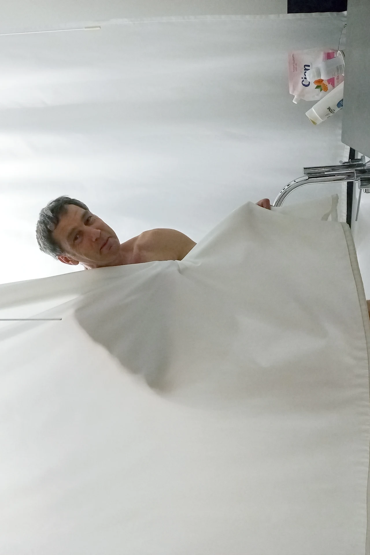 Colour-Blocked Curtain to Zone the Shower in a cozy budget bathroom with soft natural light