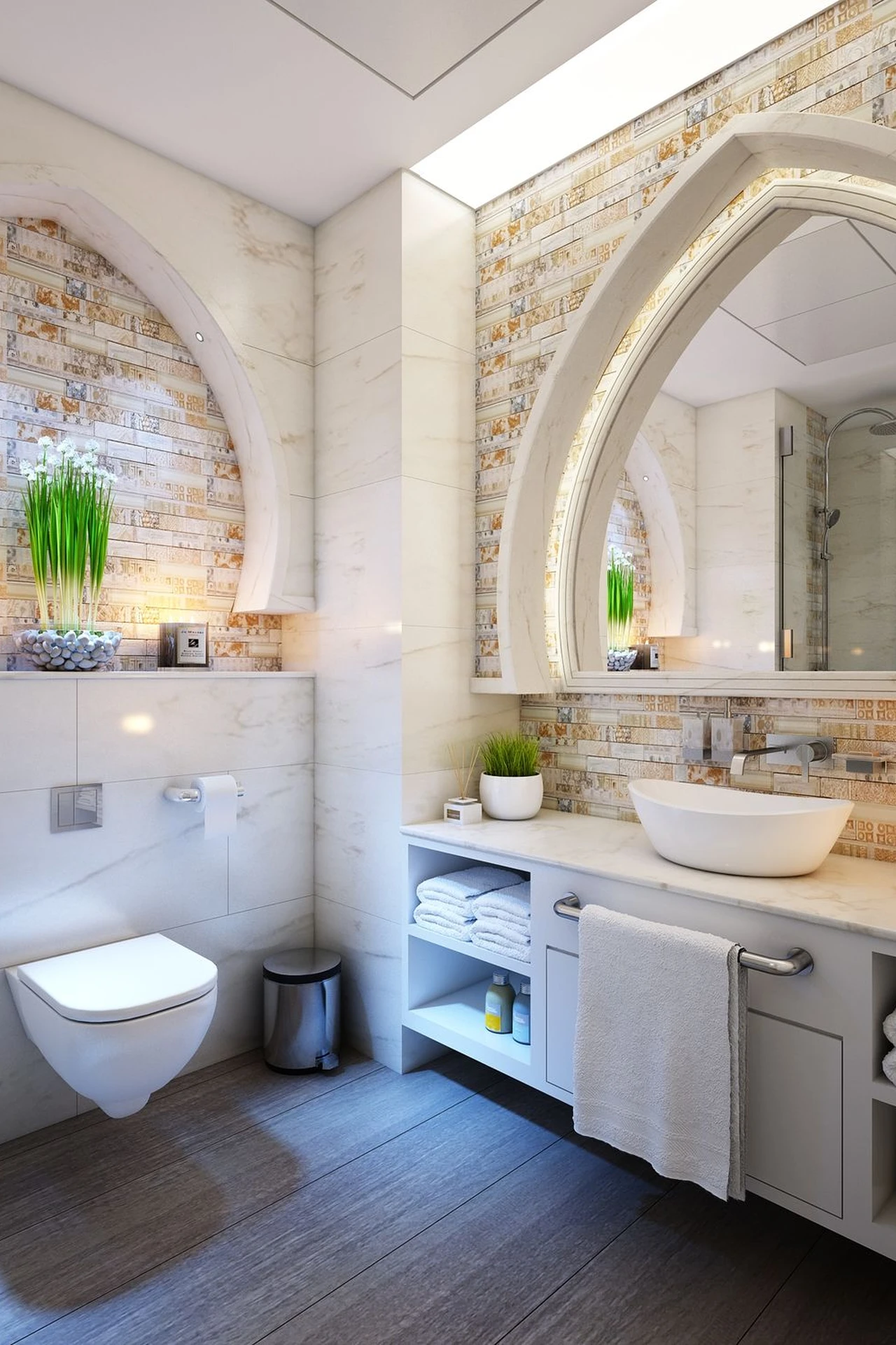 Mustard yellow hand towels hanging in a bright white bathroom