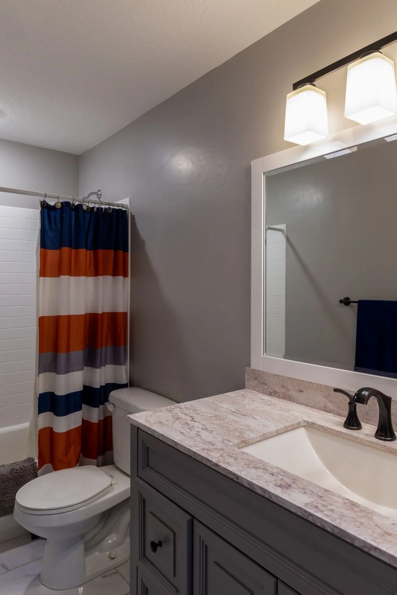 Mustard shower curtain in a cozy bathroom with white tiles