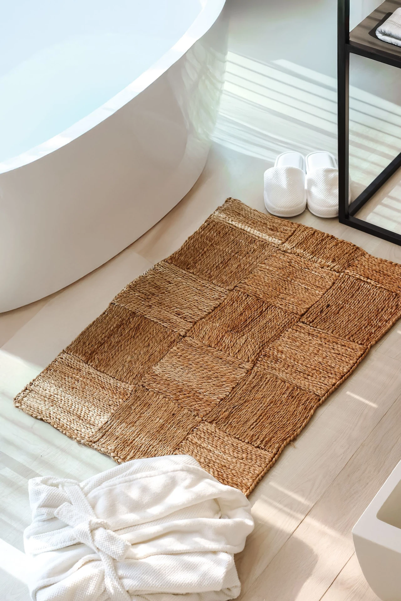 Plush mustard bath mat on white bathroom tile floor