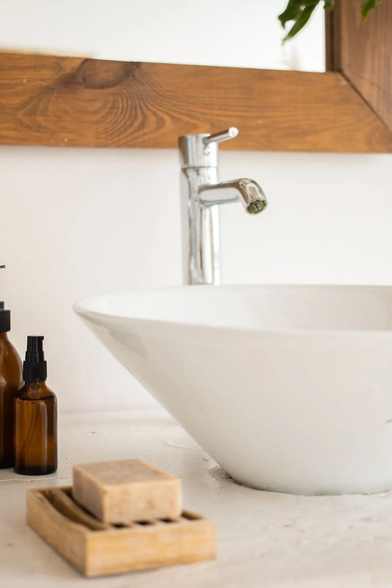 Mustard soap dispenser on a tray beside a bathroom sink