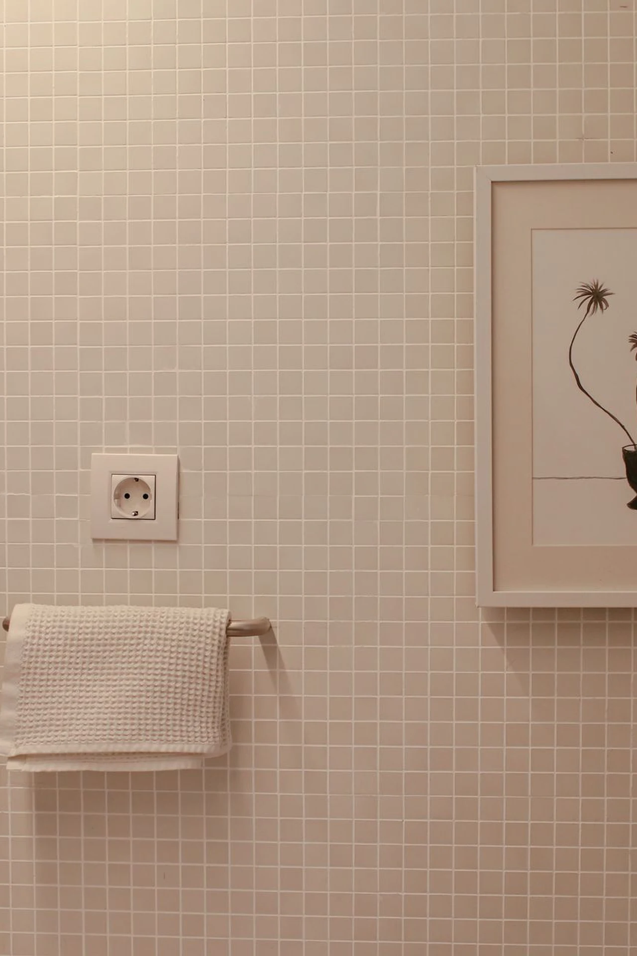 Mustard framed art prints hanging above a toilet in a bathroom