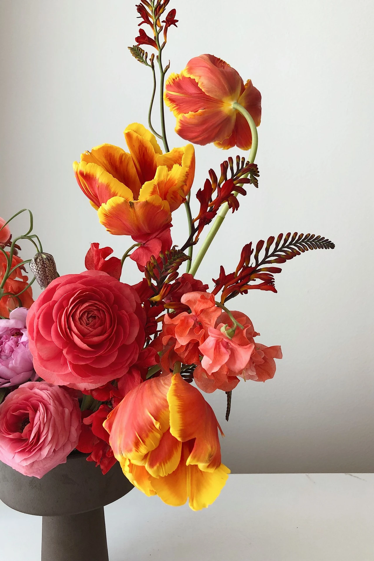 Mustard ceramic vase with dried stems on a bathroom shelf