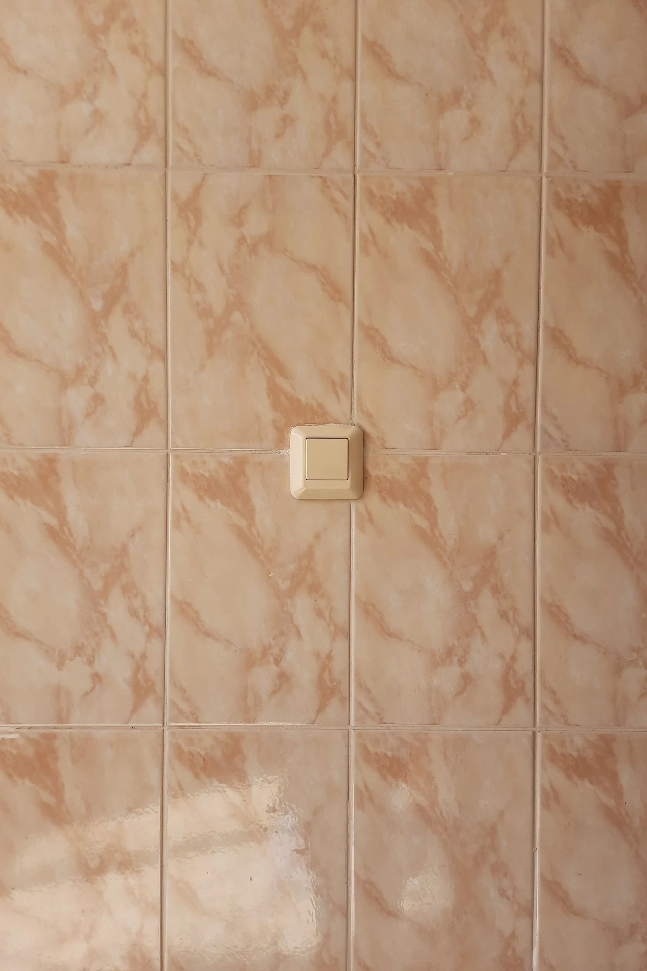 Mustard tile stickers on a bathroom backsplash wall