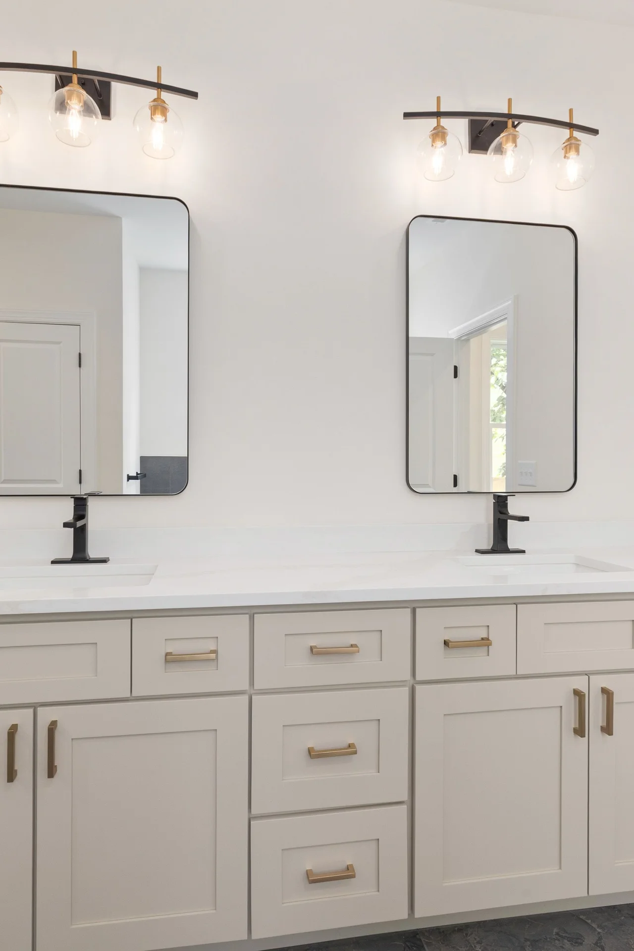 Mirrored medicine cabinet above a small bathroom sink