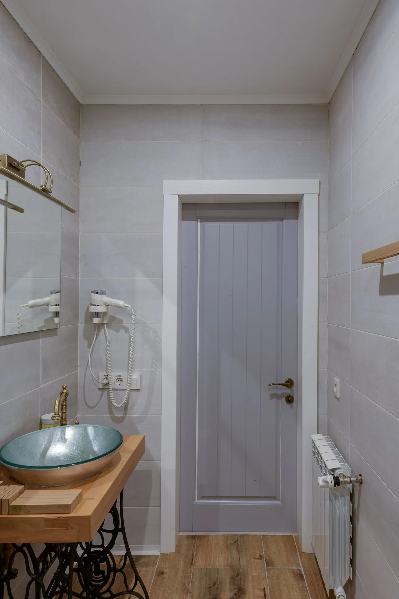 Over-the-door towel rack holding towels in a small bathroom