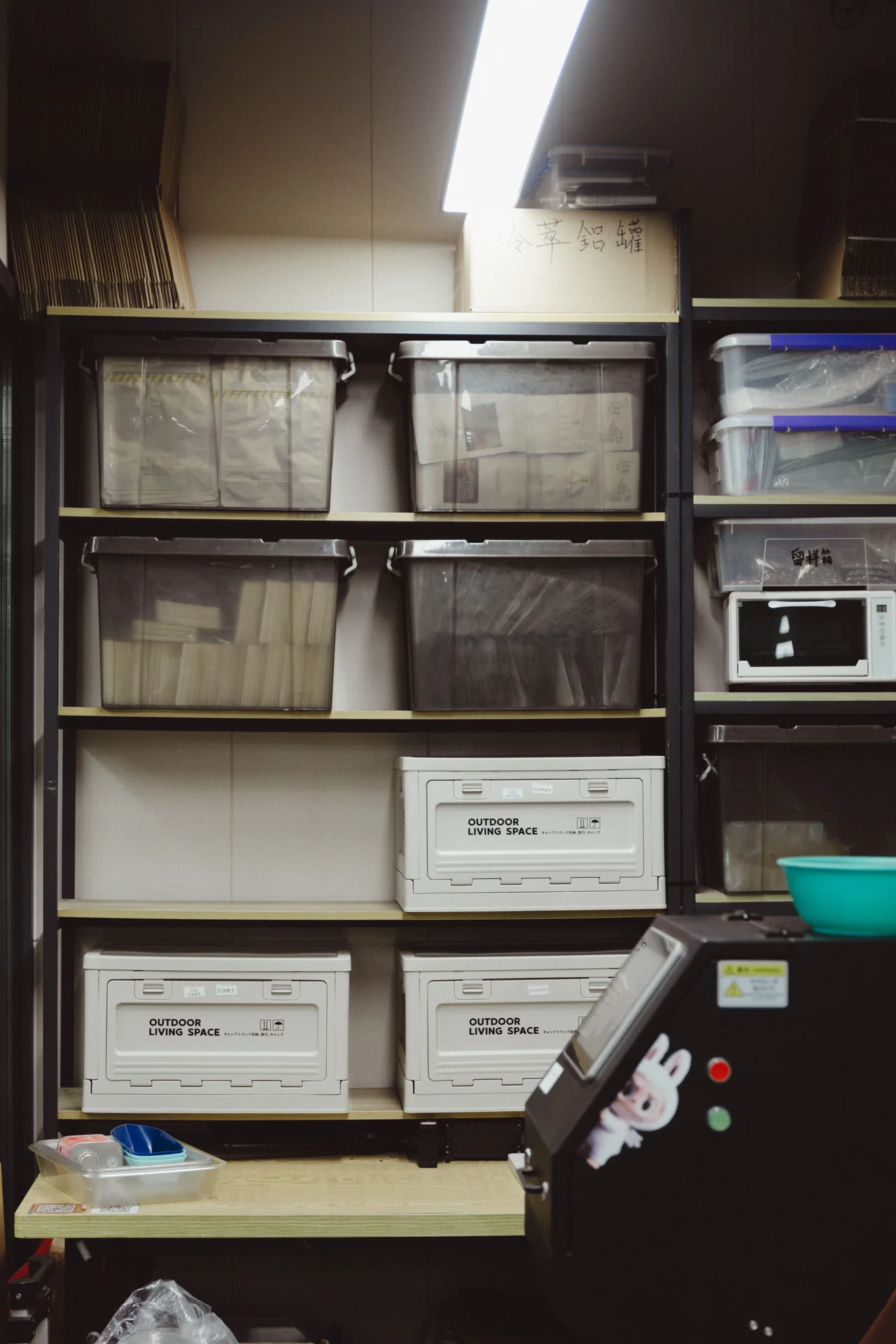 Stackable bins organizing supplies under a bathroom sink