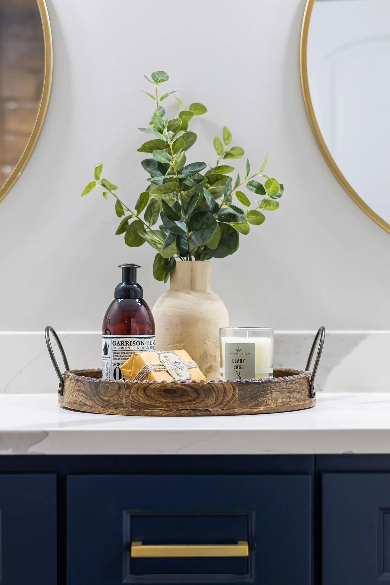Two-tier tray with skincare bottles on a bathroom vanity