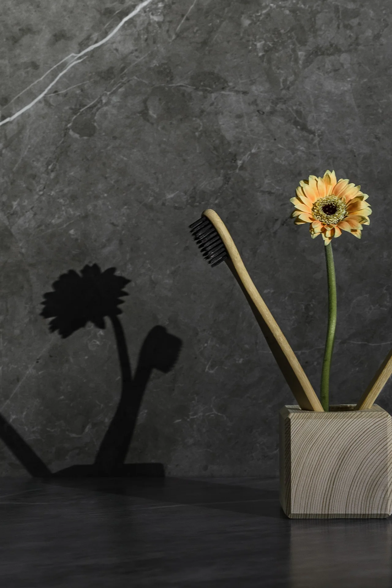 Adhesive toothbrush holder mounted on a bathroom wall near mirror
