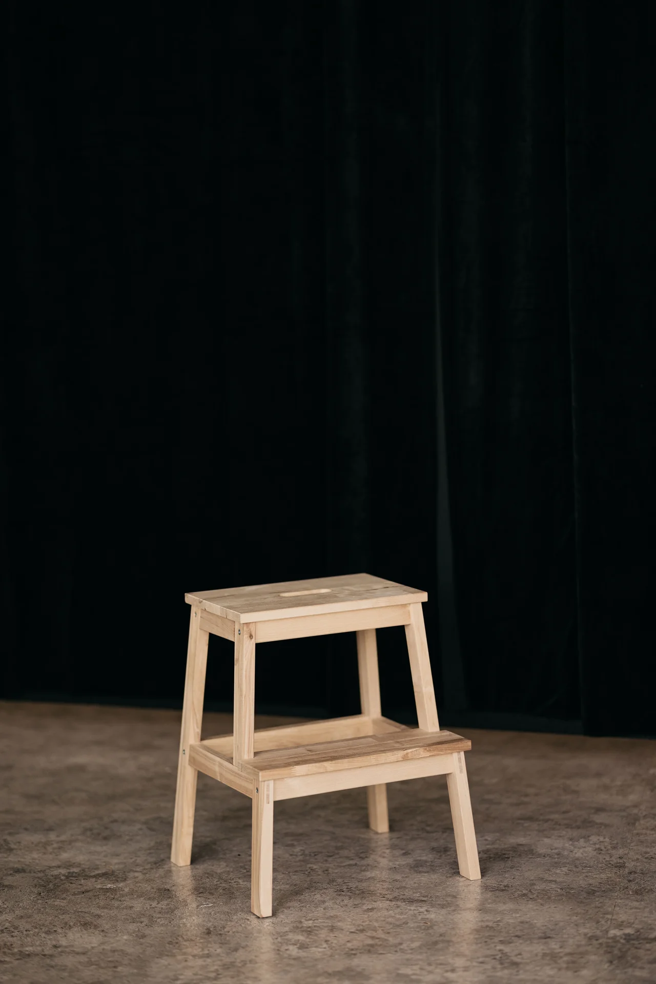 Folding step stool hanging behind a bathroom door