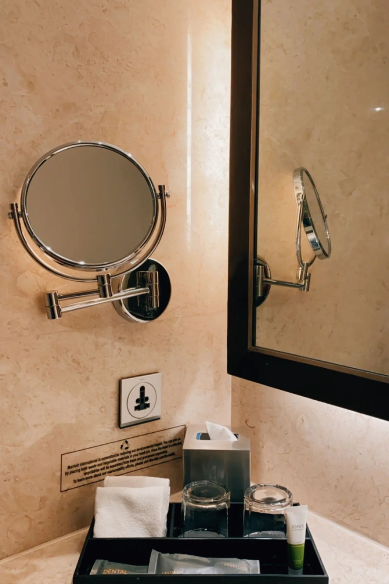 Vanity tray with daily toiletries beside a bathroom sink
