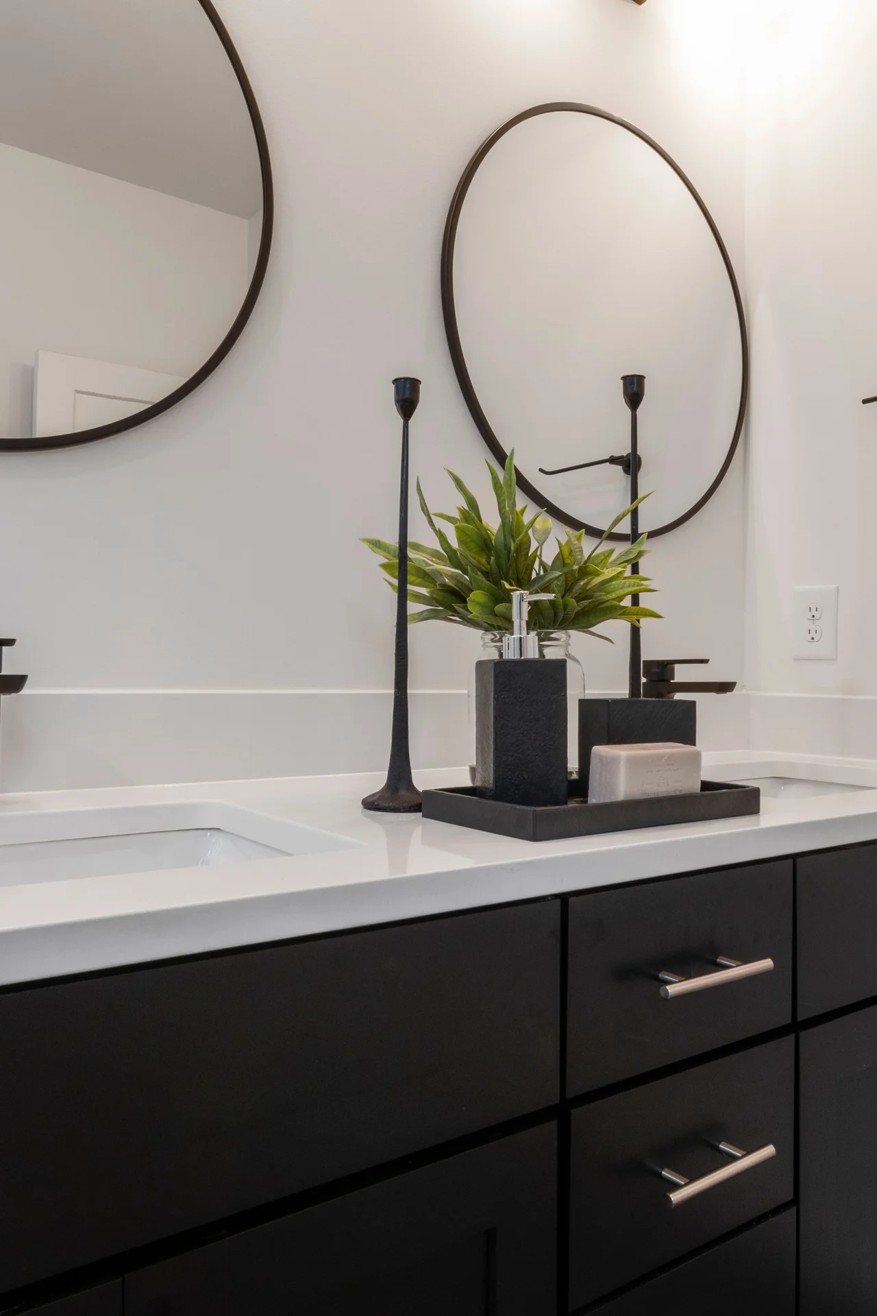 Small round mirror with brass frame reflecting light in a tiny bathroom