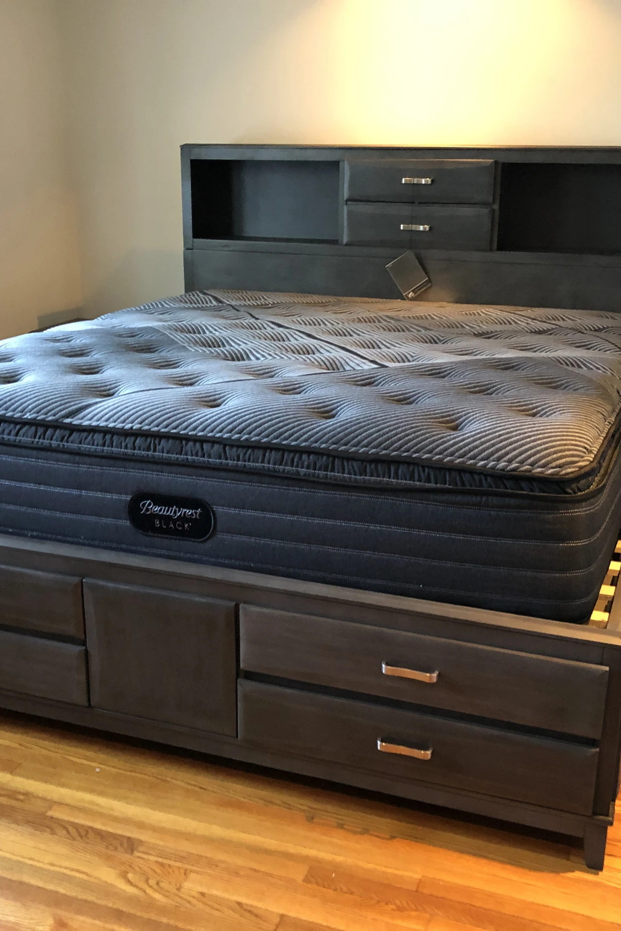 Rolling storage bins sliding out from under a bed in a small bedroom