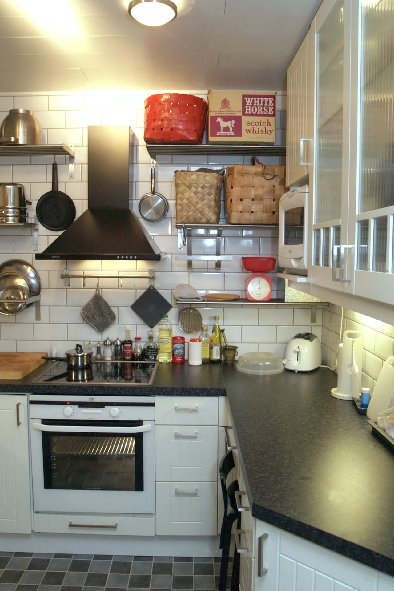 Light peel-and-stick subway tile backsplash in a small apartment kitchen