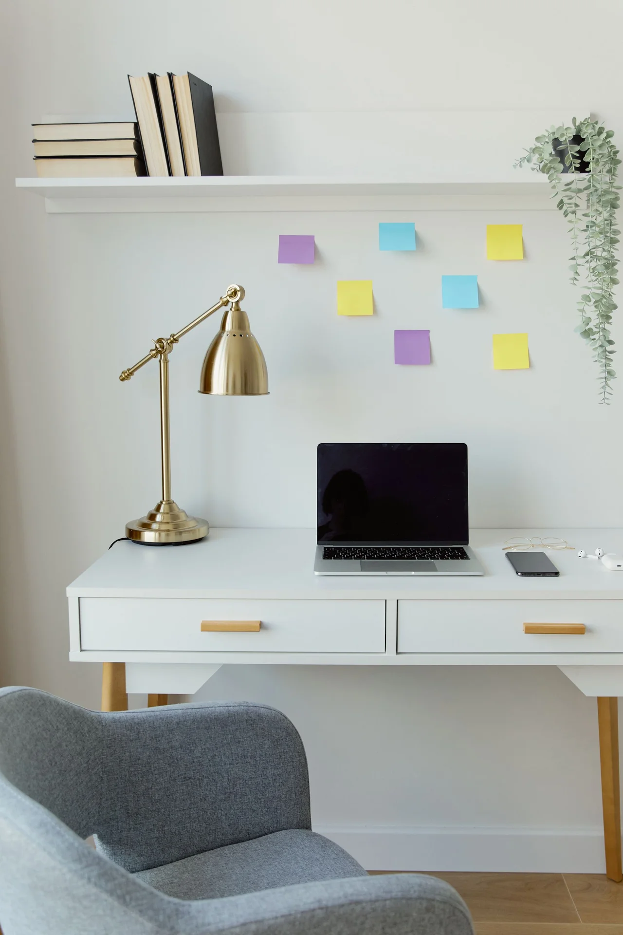 Wall-mounted folding desk in a tiny bedroom with a chair tucked beneath