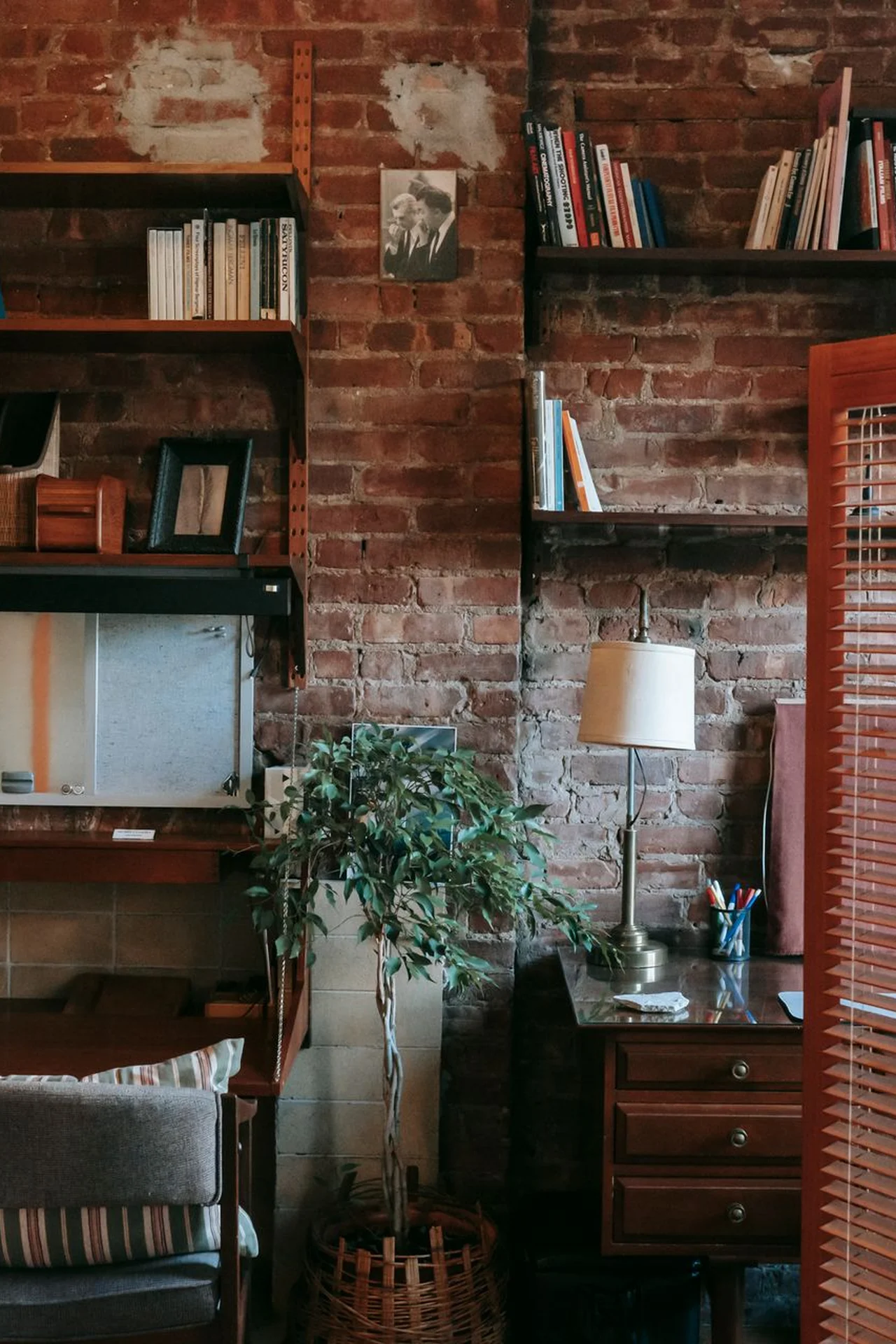 Floating shelves reaching the ceiling in a tiny bedroom with books