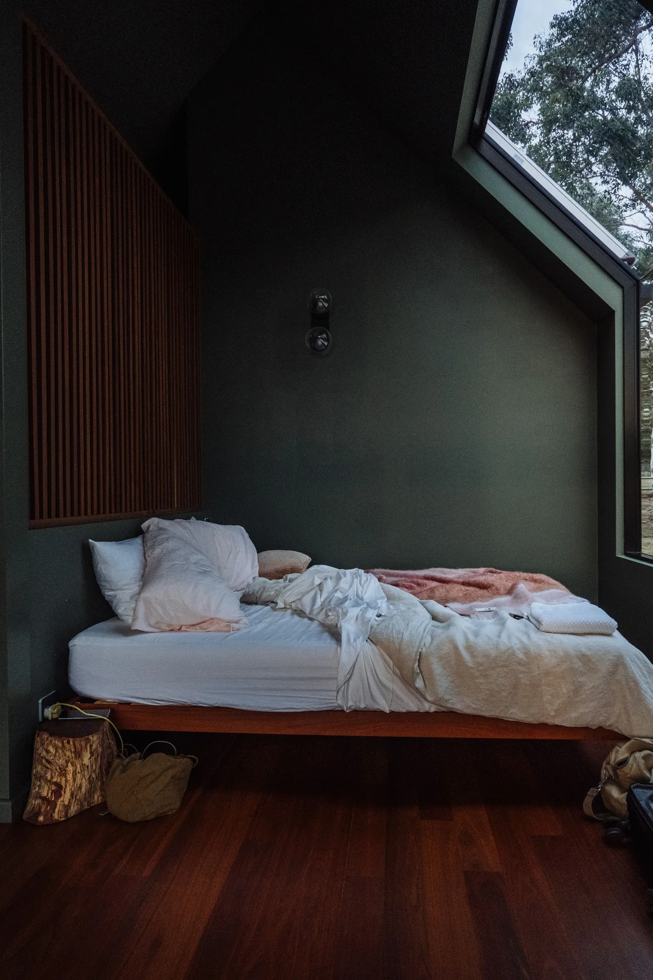 Storage bed with deep drawers open in a small bedroom
