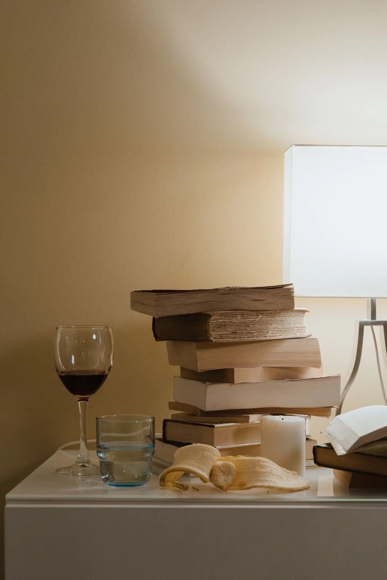 Small rolling cart used as a nightstand beside a bed in a tiny bedroom