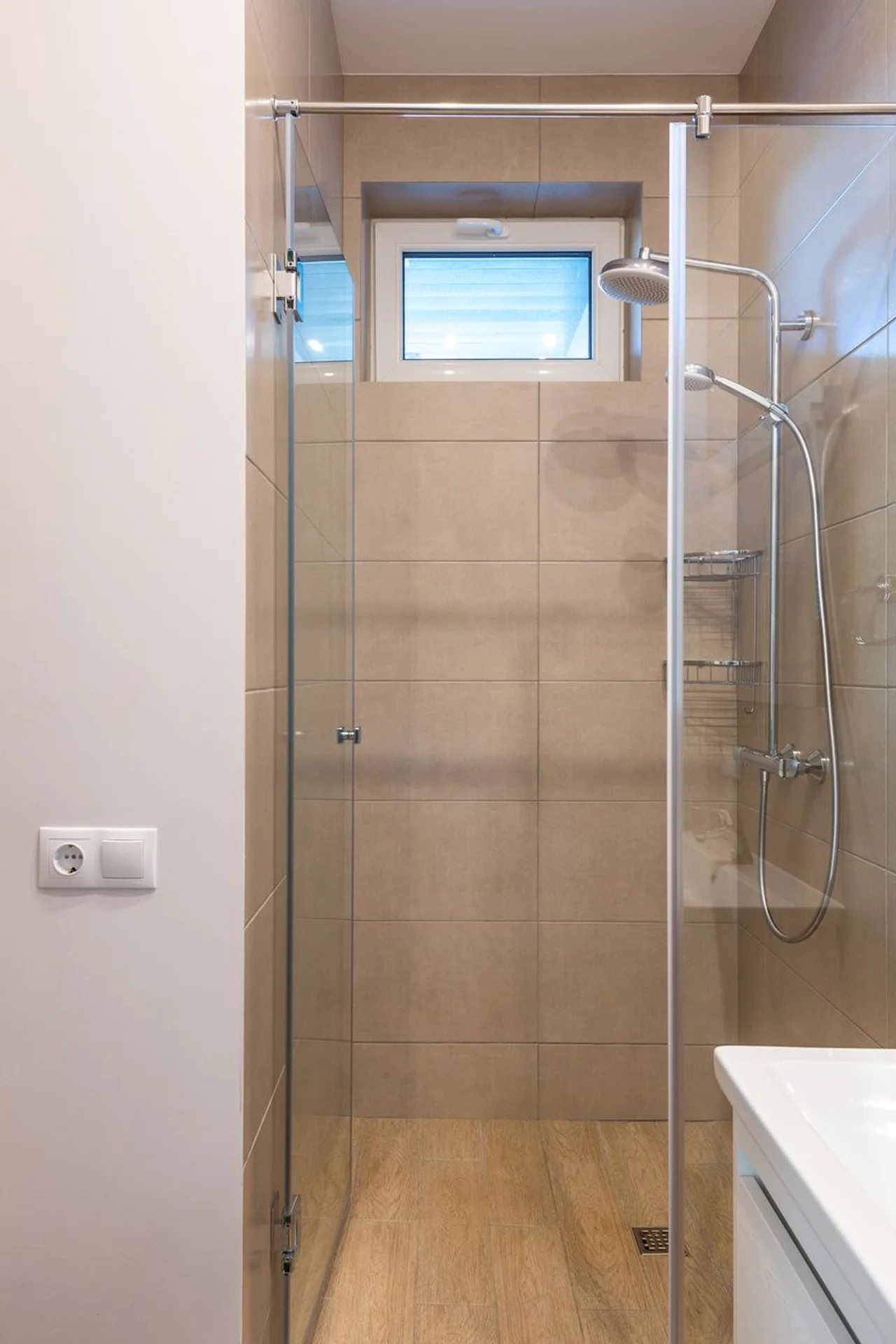 Small bathroom with a patterned shower curtain and white tiles