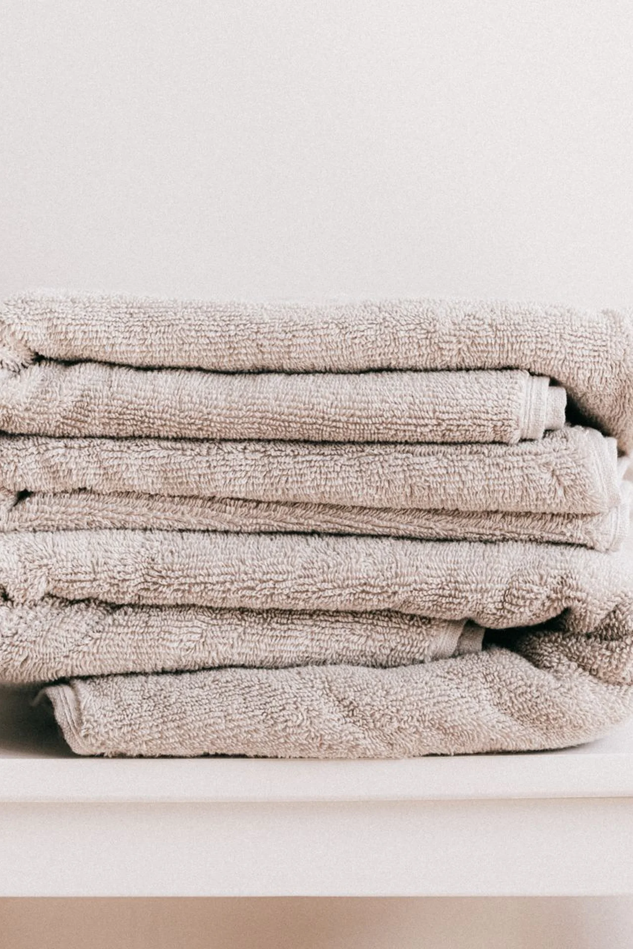 Baskets with rolled towels in a tiny bathroom