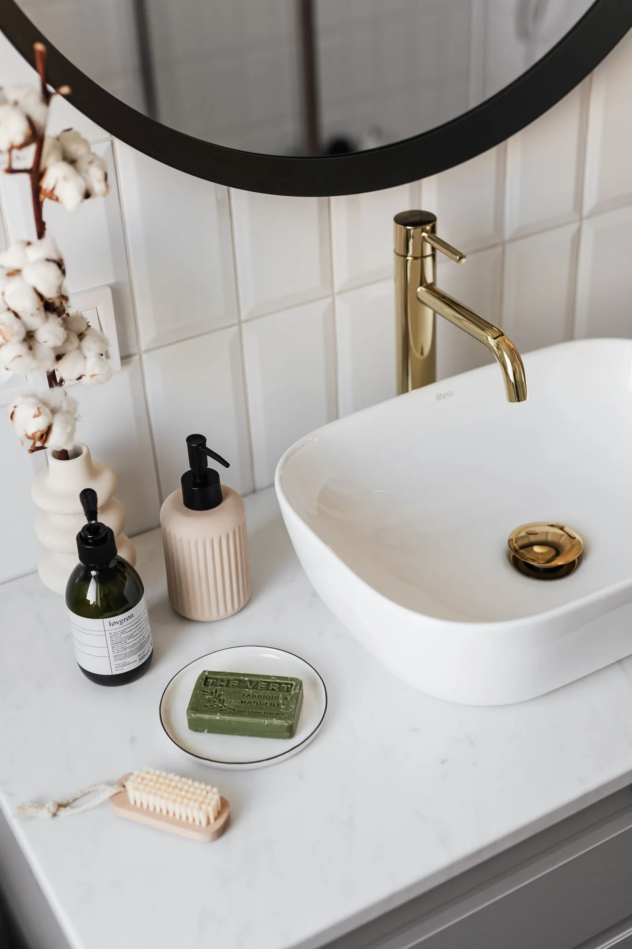 Small bathroom counter with a tray holding soap and toiletries