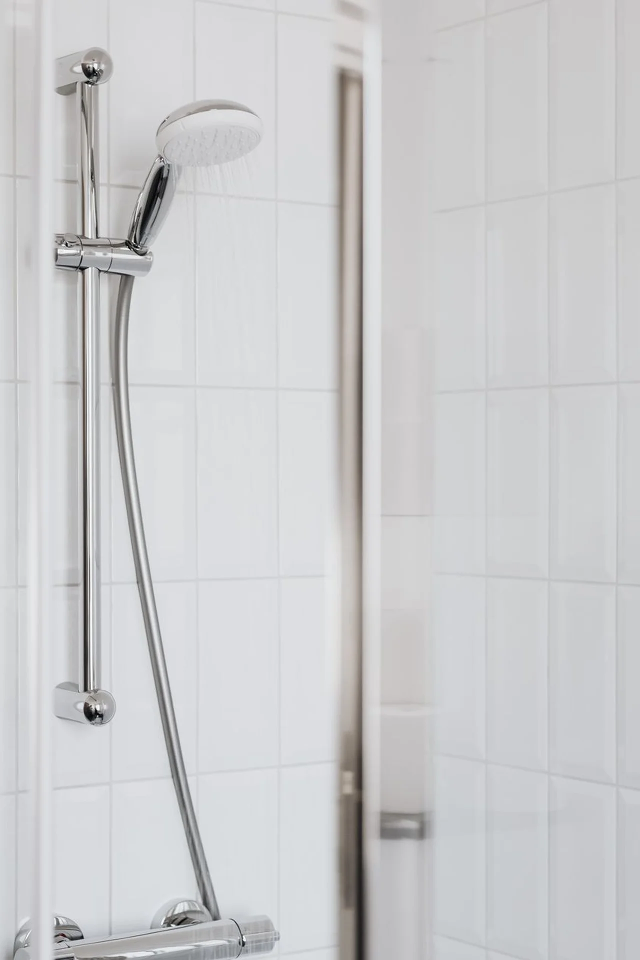 Stainless shower caddy with bottles in a small shower