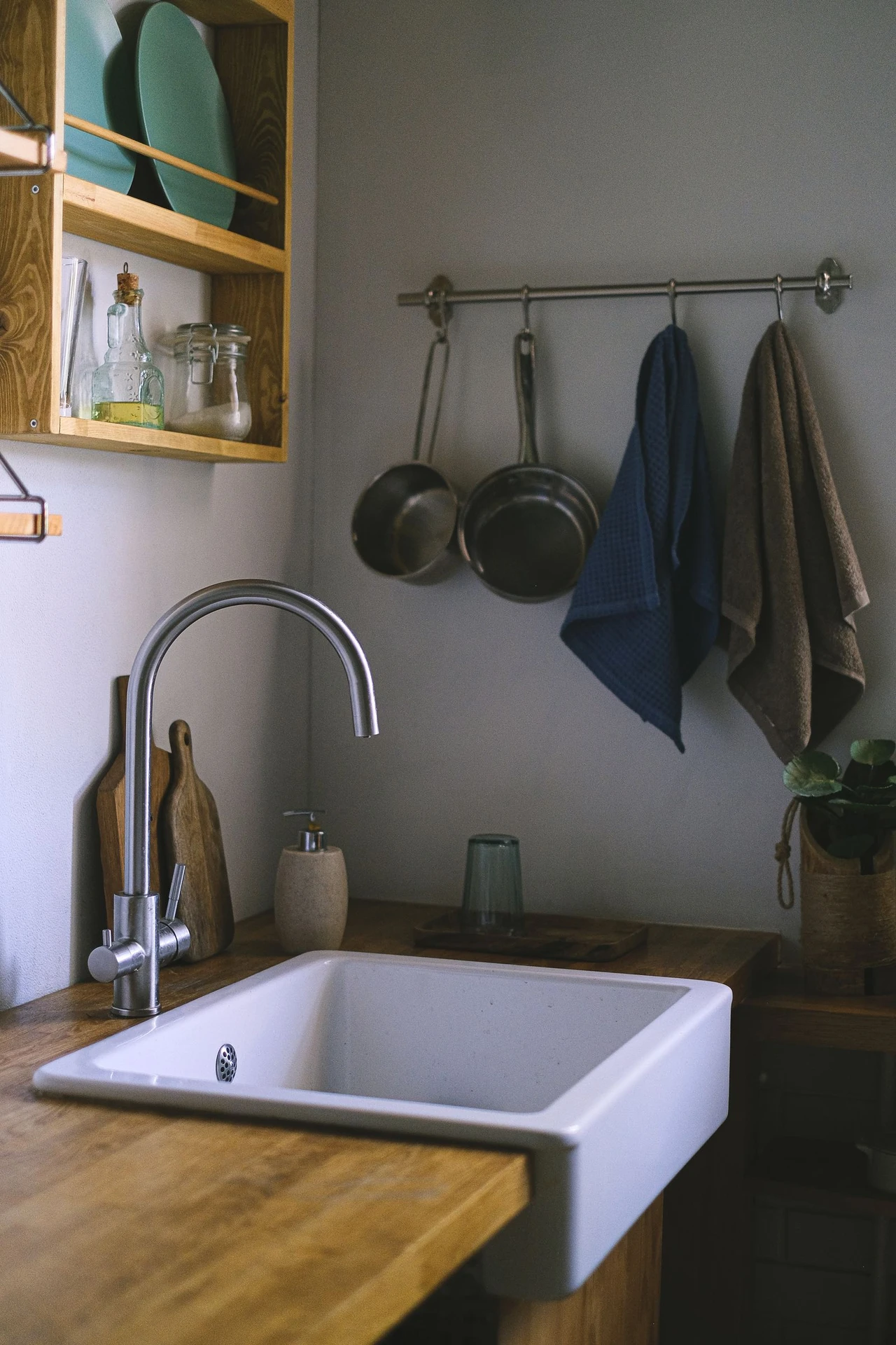 Add a Tension Rod Under the Sink in a small apartment