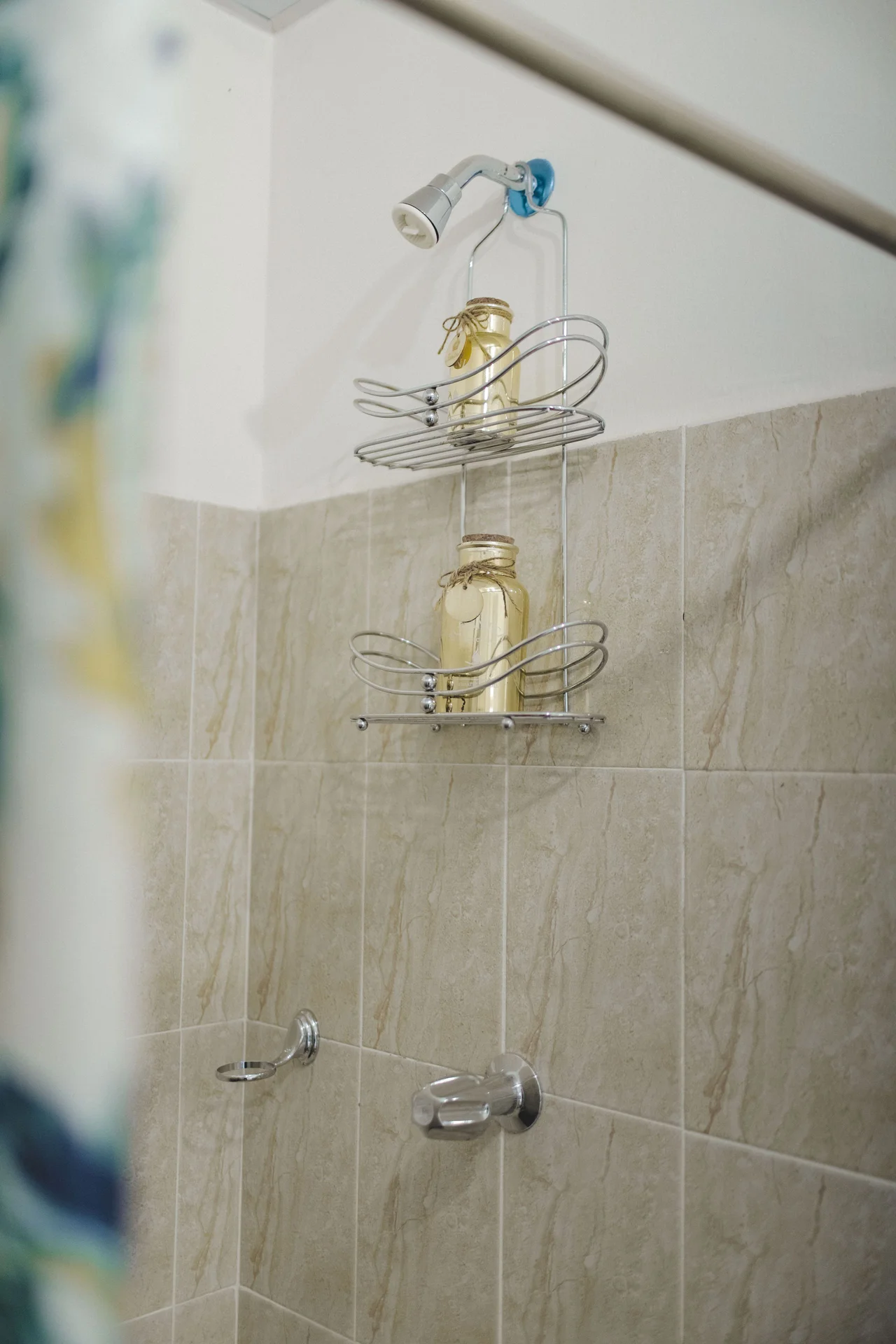 Hang a Clear Shower Caddy From the Showerhead in a small budget-friendly apartment
