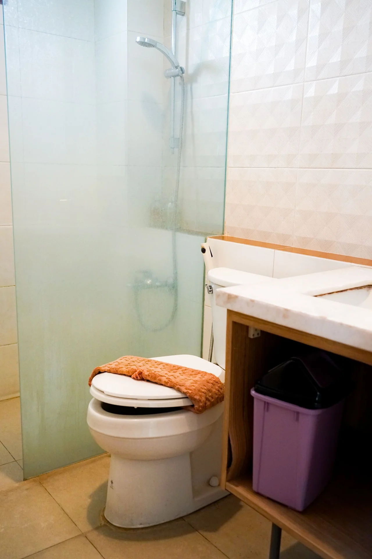Squeeze a Slim Rolling Cart Beside the Toilet in a small budget-friendly apartment