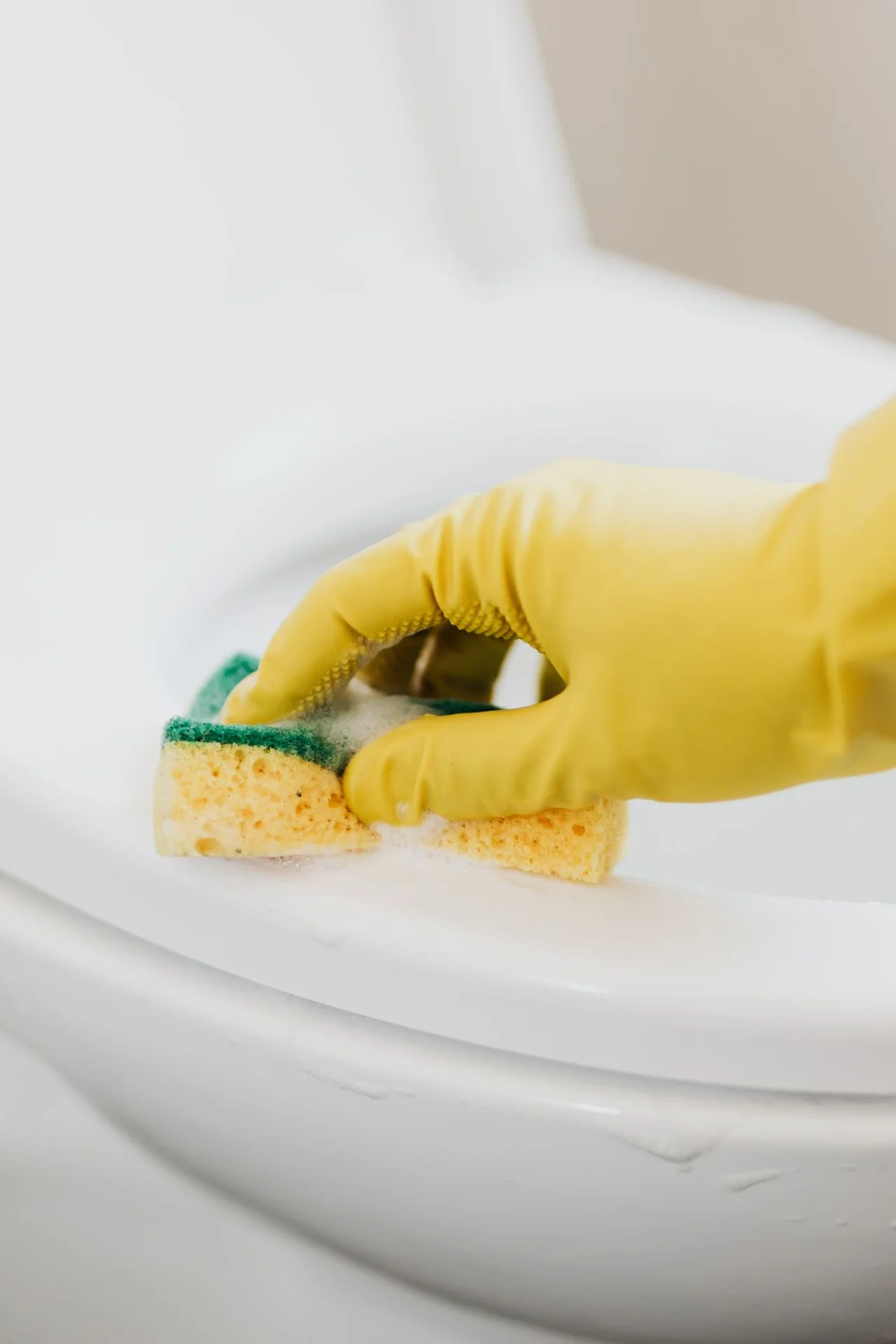 Hang a Tension Rod Under the Sink for Sprays in a small budget-friendly apartment